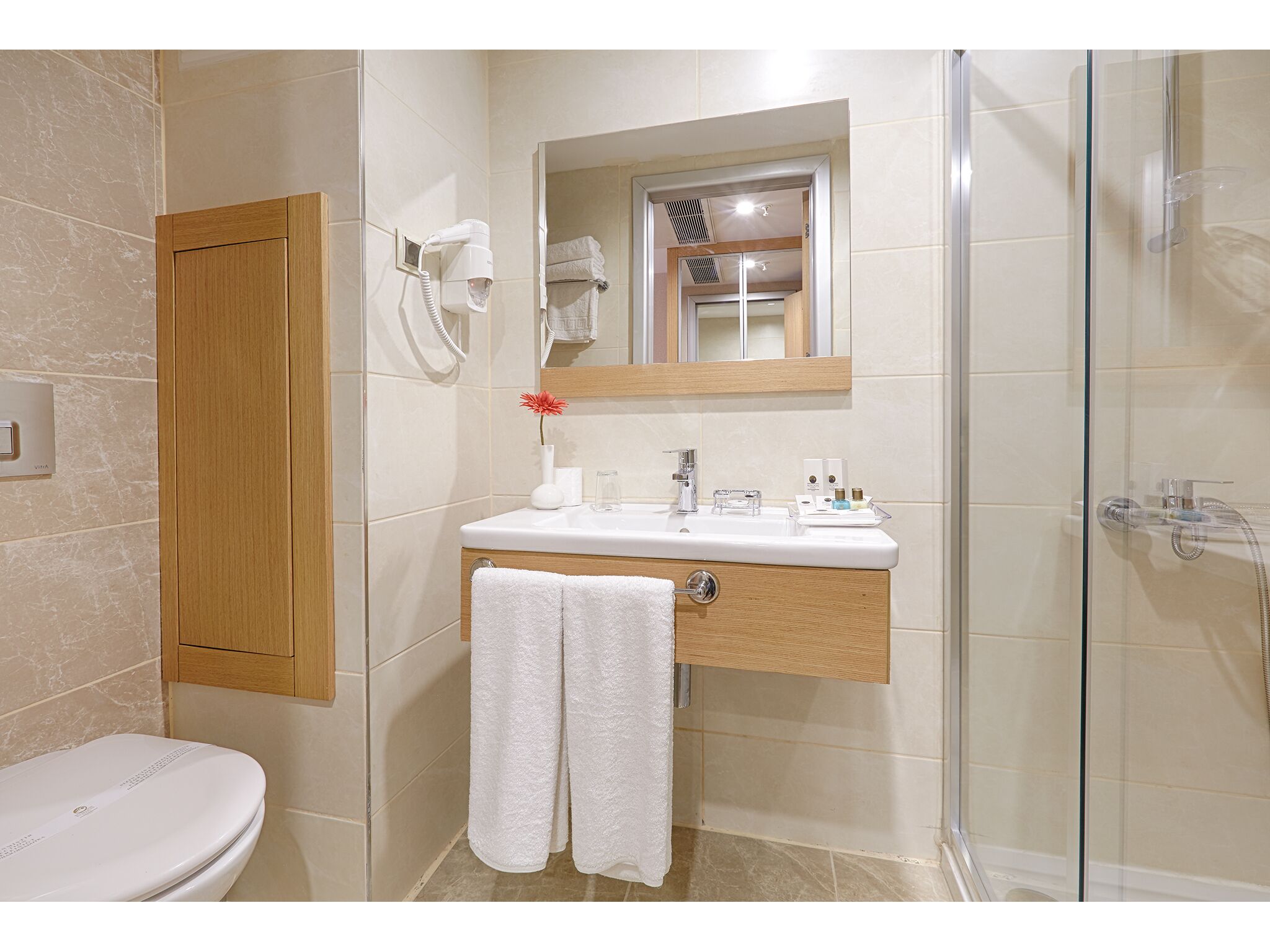 shower, designer toiletries, hair dryer, slippers