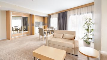 Suite, 1 King Bed with Sofa bed, Balcony, Corner | Living area | 36-inch LCD TV with satellite channels, TV