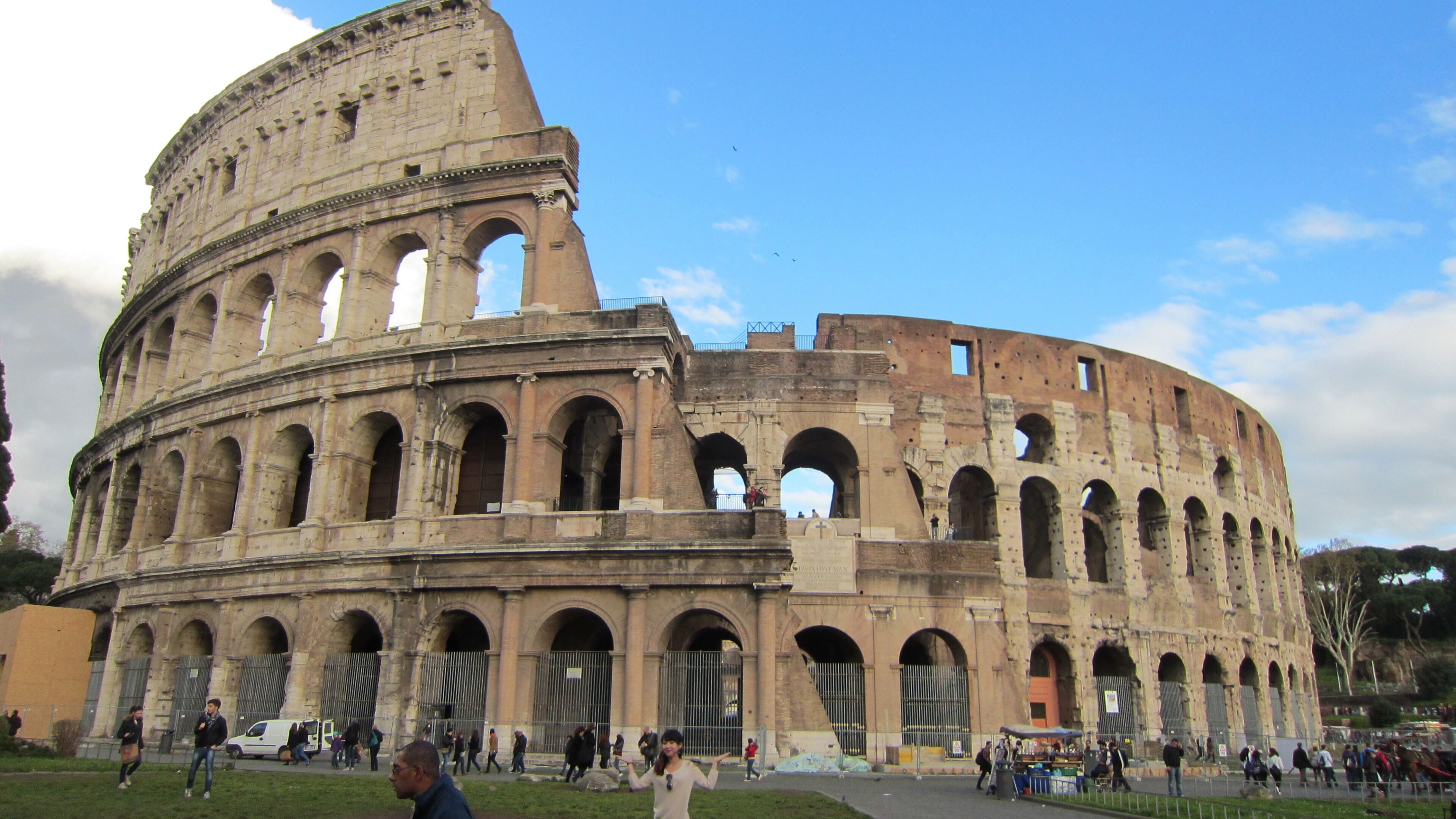 A large historical building with multiple arches and a dome.
