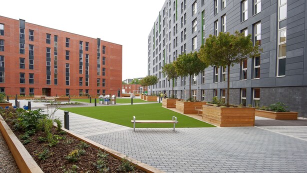 A modern building with a brick facade and a grey exterior. - Peel Park Quarter - Campus Accommodation (Salford)