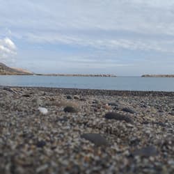 On the beach, white sand, sun loungers, beach towels