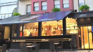 A bar and restaurant named 'Hotel Atlana' with outdoor seating and a neon sign. - Hotel Aitana (Irun)