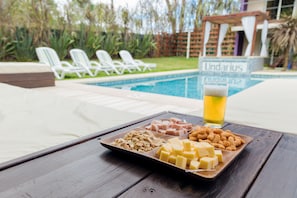 Piscine extérieure en saison, parasols, chaises longues