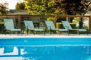 Seasonal outdoor pool, open 9:00 AM to 9:00 PM, sun loungers