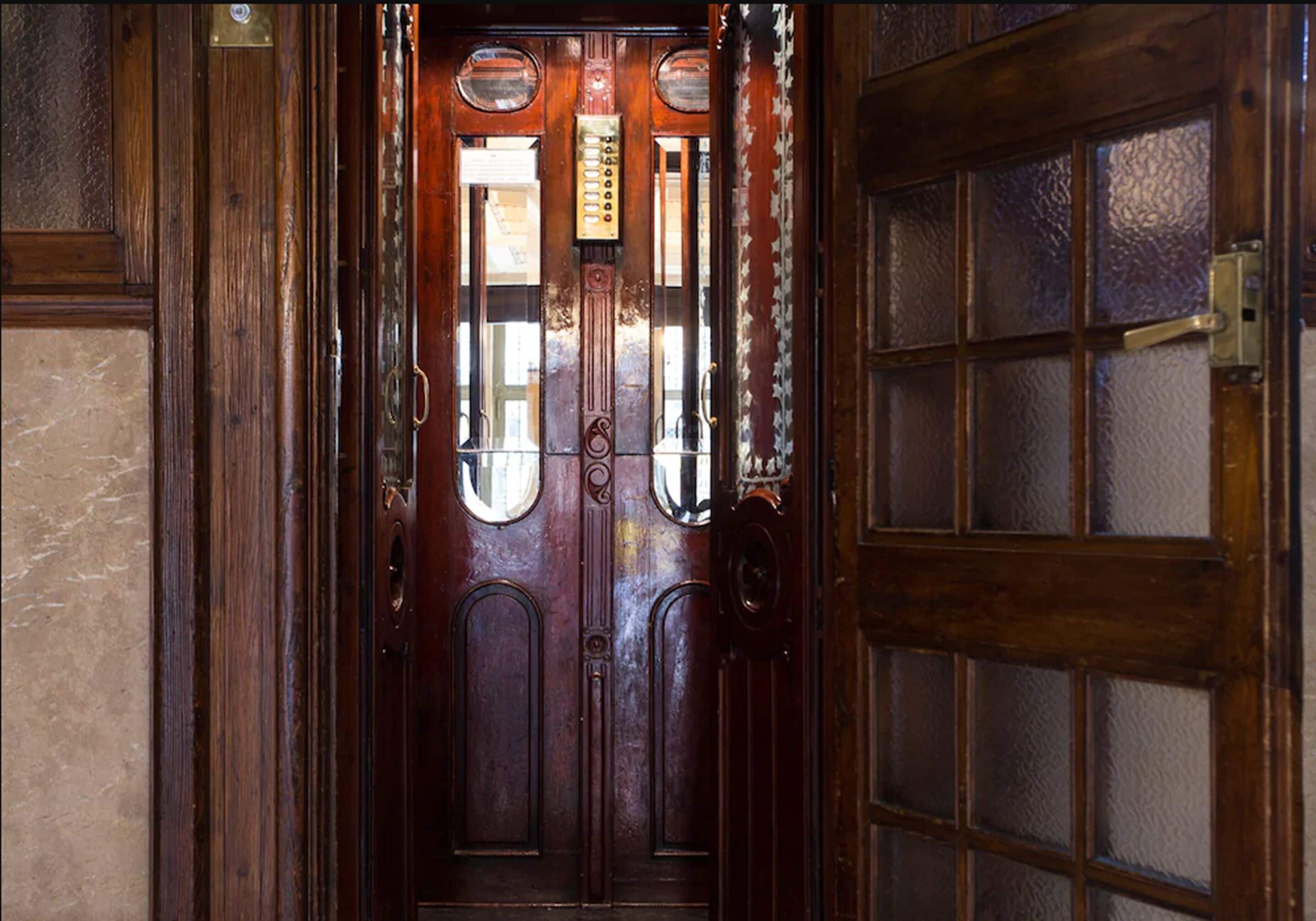 A wooden door with glass panels and a brass handle.