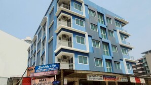 A multi-story building with balconies and air conditioning units. - Zenith Life (Nonthaburi)