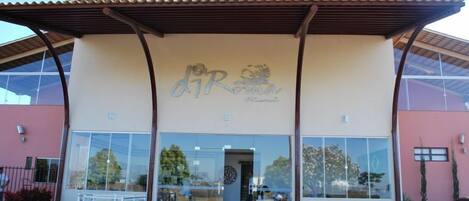 A building with a large glass facade, a prominent sign with the text "DIR", and a covered entrance area.