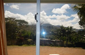 Enjoy the serene view of the surrounding mountains and lush greenery from the comfort of your room.