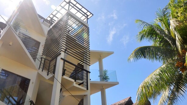 A modern multi-story building with balconies and large windows. - White Coral Hotel (Boracay Island)