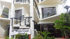 A multi-story building with a sign reading "White Coral Hotel". - White Coral Hotel (Boracay Island)