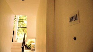 A hallway with a staircase leading to a room labeled "JOWELL". - White Coral Hotel (Boracay Island)