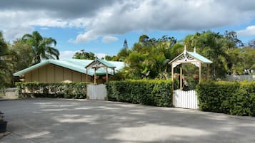 Enter a serene oasis with a beautifully maintained garden and a charming gated entrance.