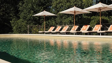 Seasonal outdoor pool, open 8:00 AM to 8:00 PM, pool loungers