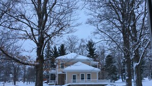 A two-story house with a snow-covered roof and a front porch. - Crystal Run Suites of Springboro (Springboro)