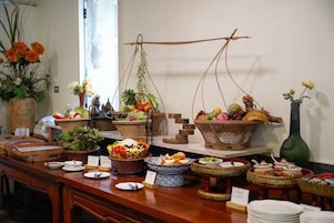 A buffet table with various food items and decorative elements.