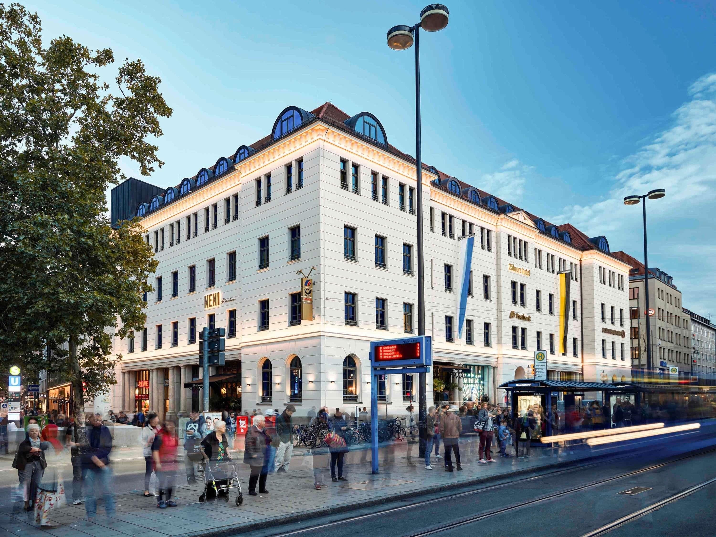 A multi-story hotel with a classic architectural design, featuring a prominent entrance and a large sign.