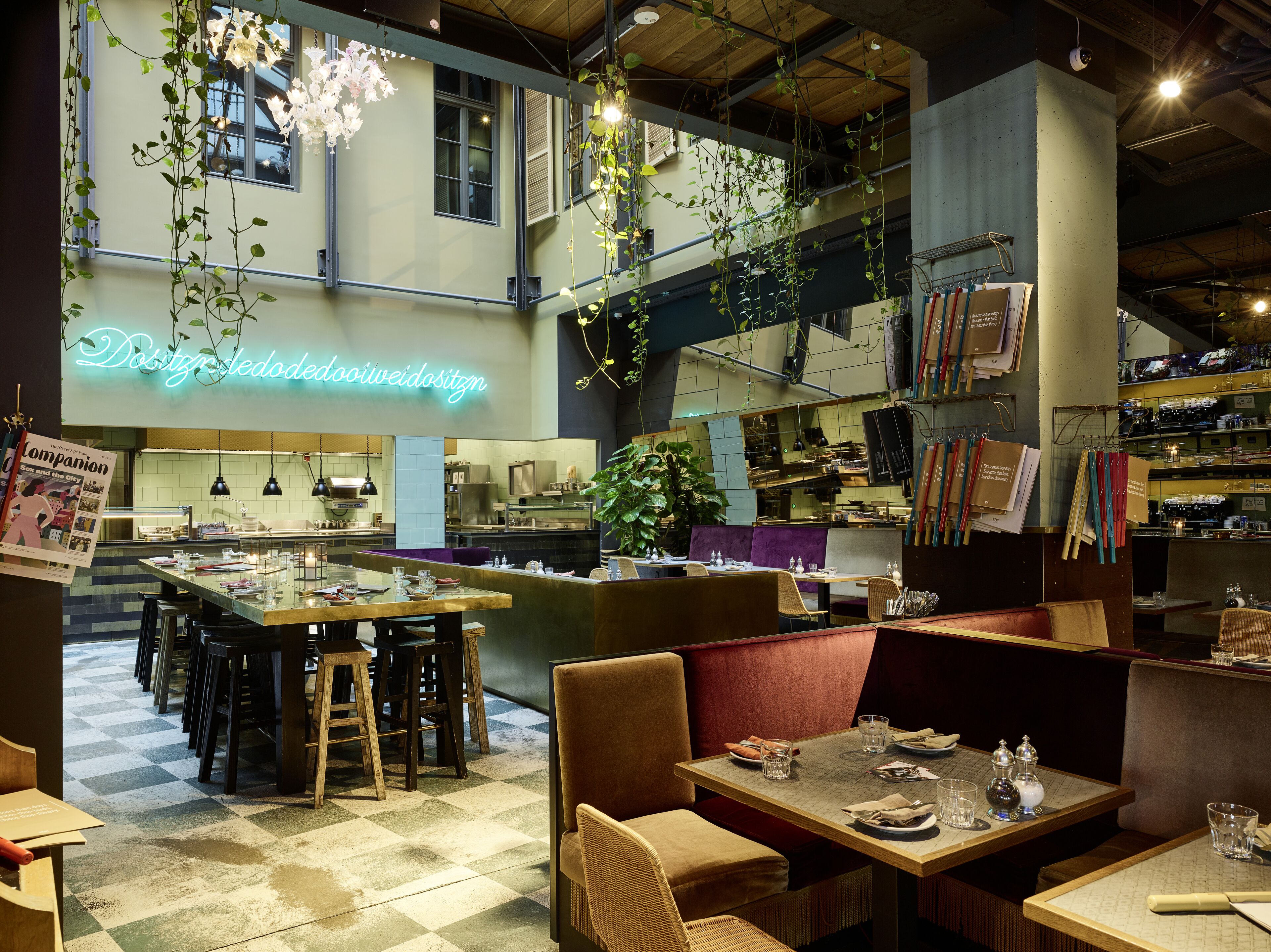 A restaurant with a checkered floor, wooden tables, and booths.