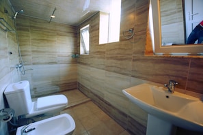 A bathroom with a toilet, bidet, sink, and shower. - Abastumani Residence (Abastumani)