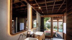 A modern bathroom with two sinks, a large mirror, and a view of a pool. - Yana Villas Kemenuh by GenuineHost (Sukawati)