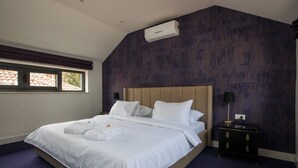 A hotel room with a large bed, a nightstand, a lamp, and a window with curtains. - Villa Diamond (Zupa dubrovacka)