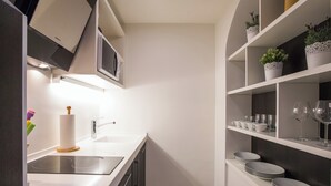 A modern kitchen with a built-in dishwasher, a stainless steel sink, and a white countertop. - Villa Diamond (Zupa dubrovacka)