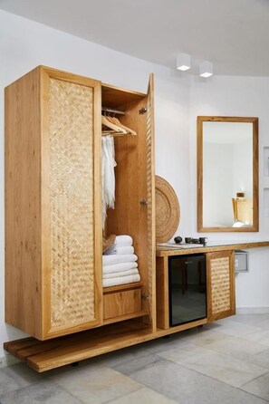 A wooden wardrobe with a mirrored cabinet and a small shelf. - Kalergis Studios (Naxos)