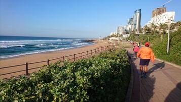 On the beach, white sand, beach umbrellas, beach towels