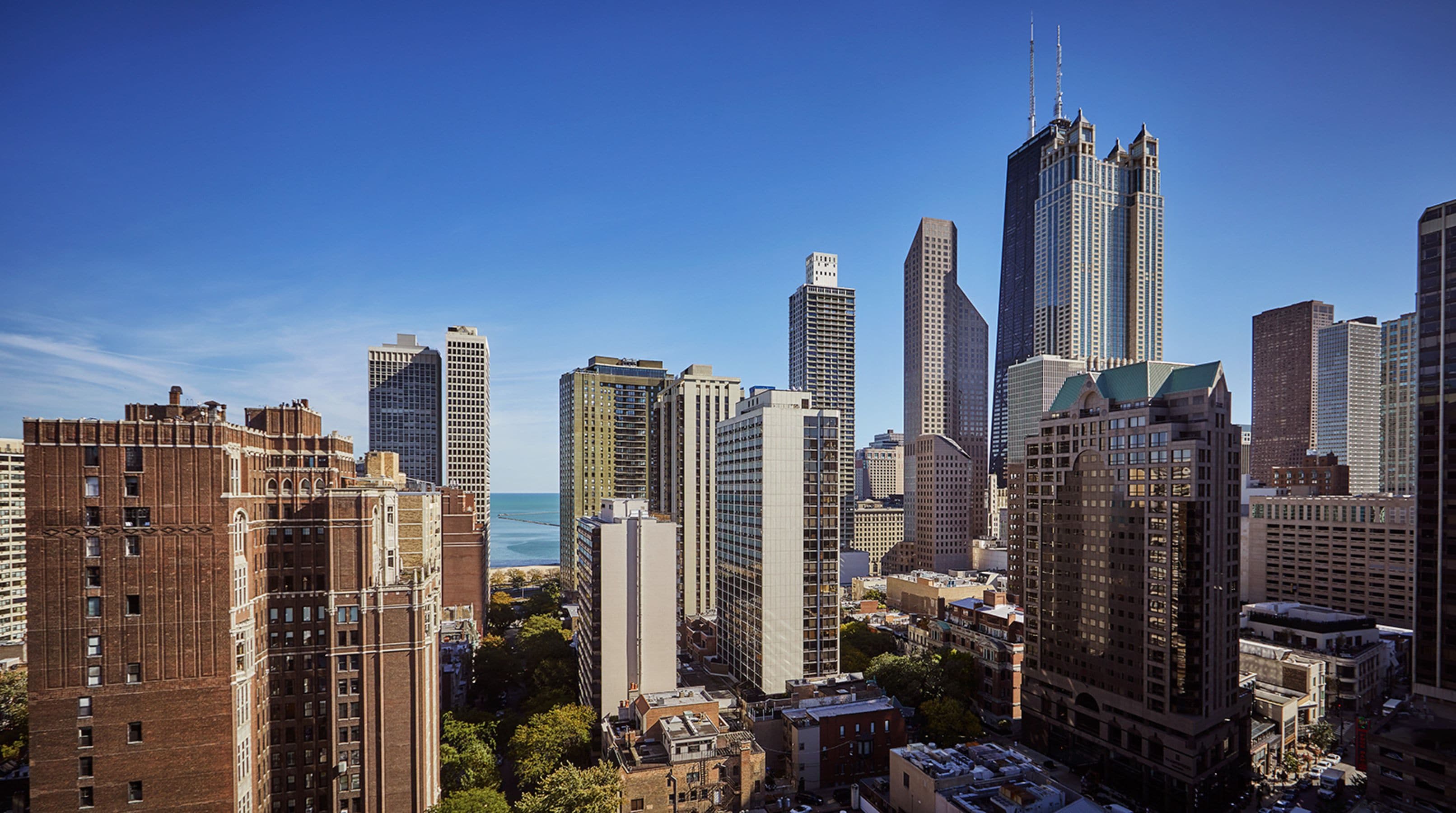 A cityscape with a variety of high-rise buildings, including some with distinctive architectural features.