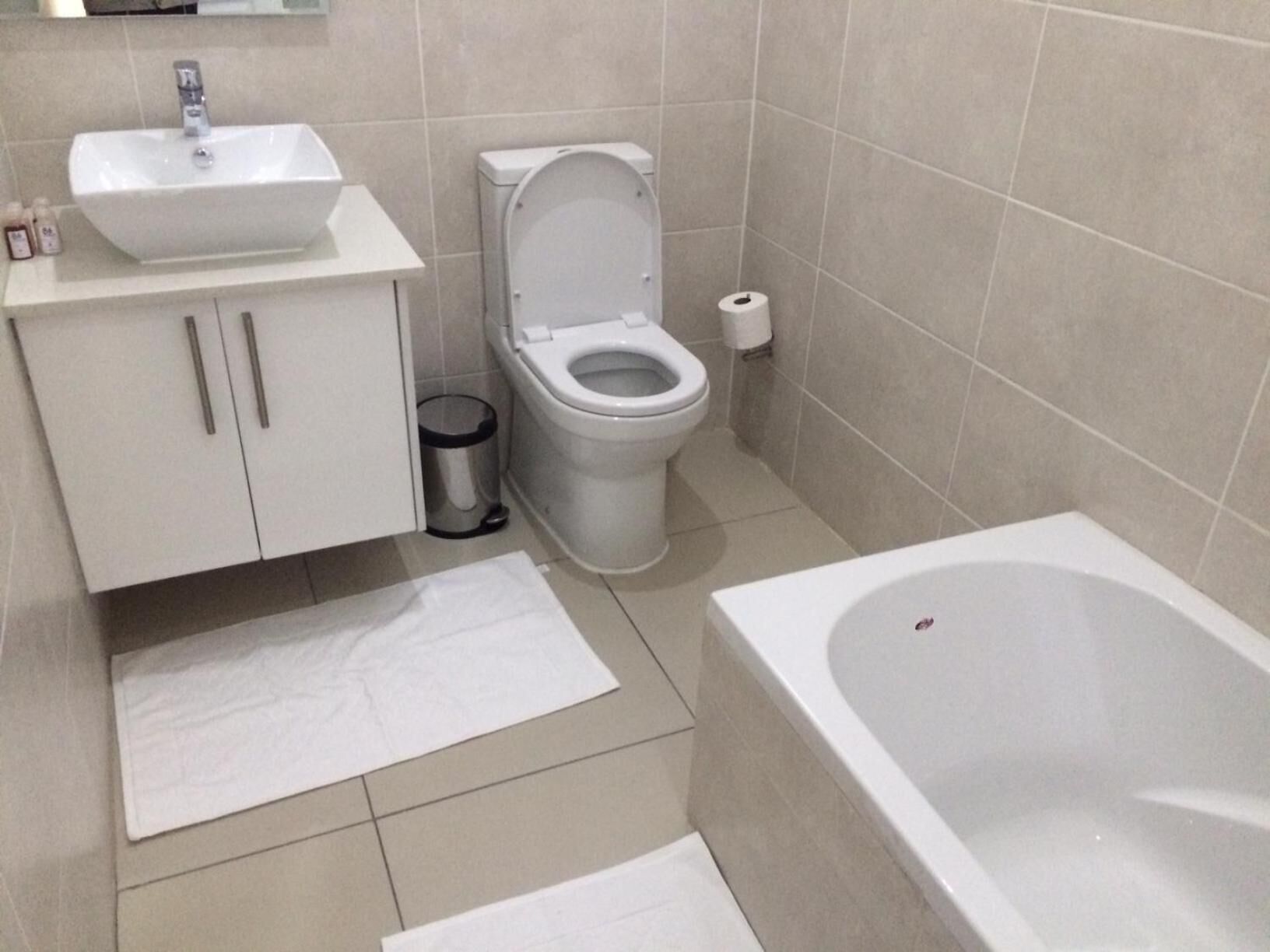 A bathroom with a sink, toilet, and bathtub.