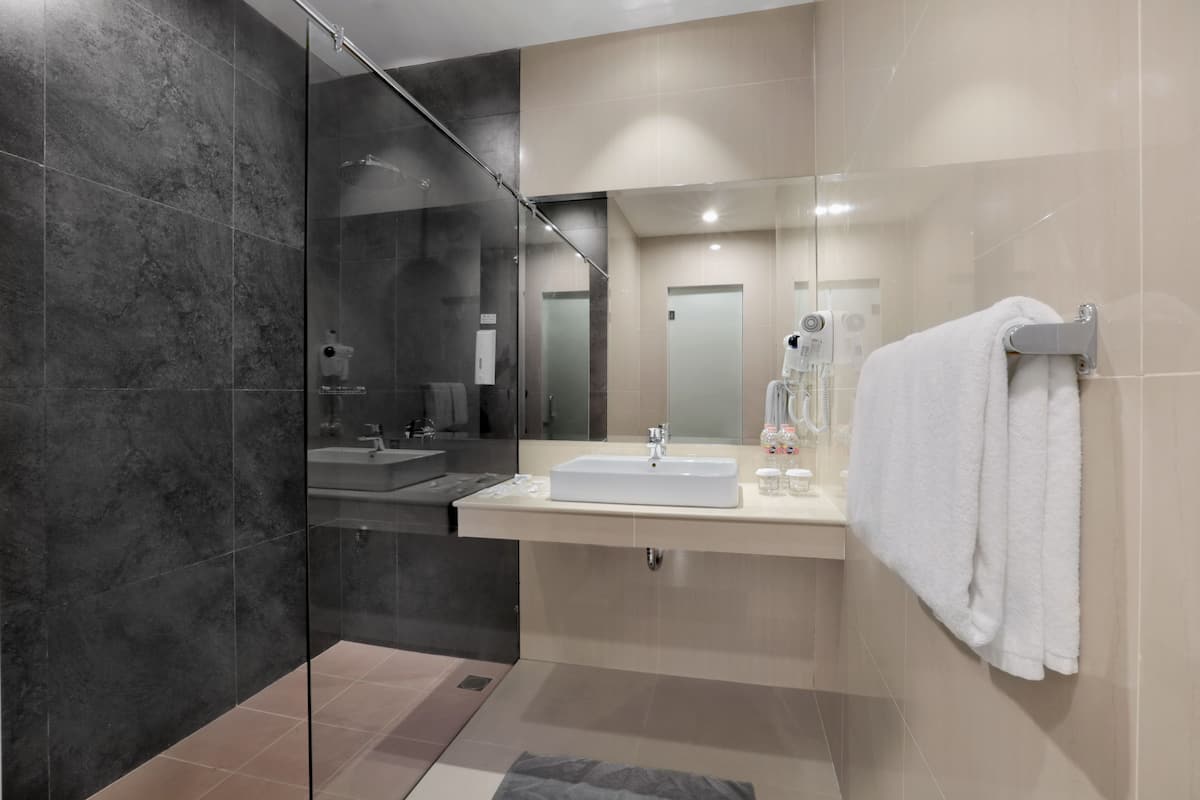 suite | bathroom | shower, slippers, towels
