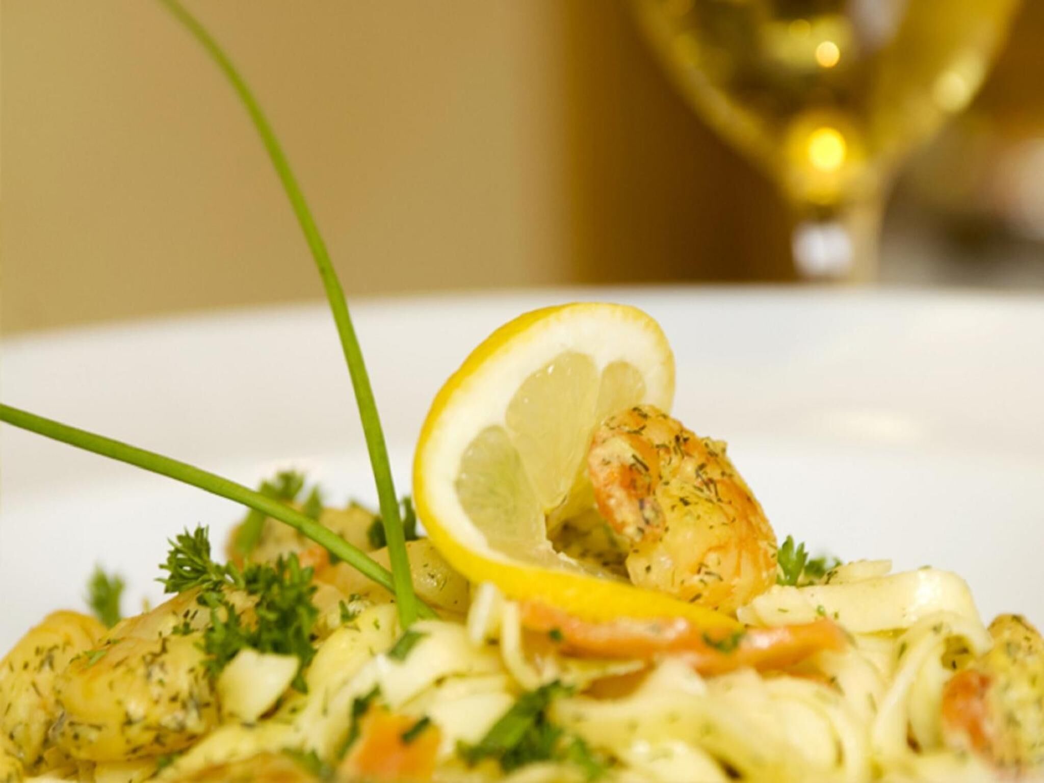 A plate of food with a lemon slice and herbs.