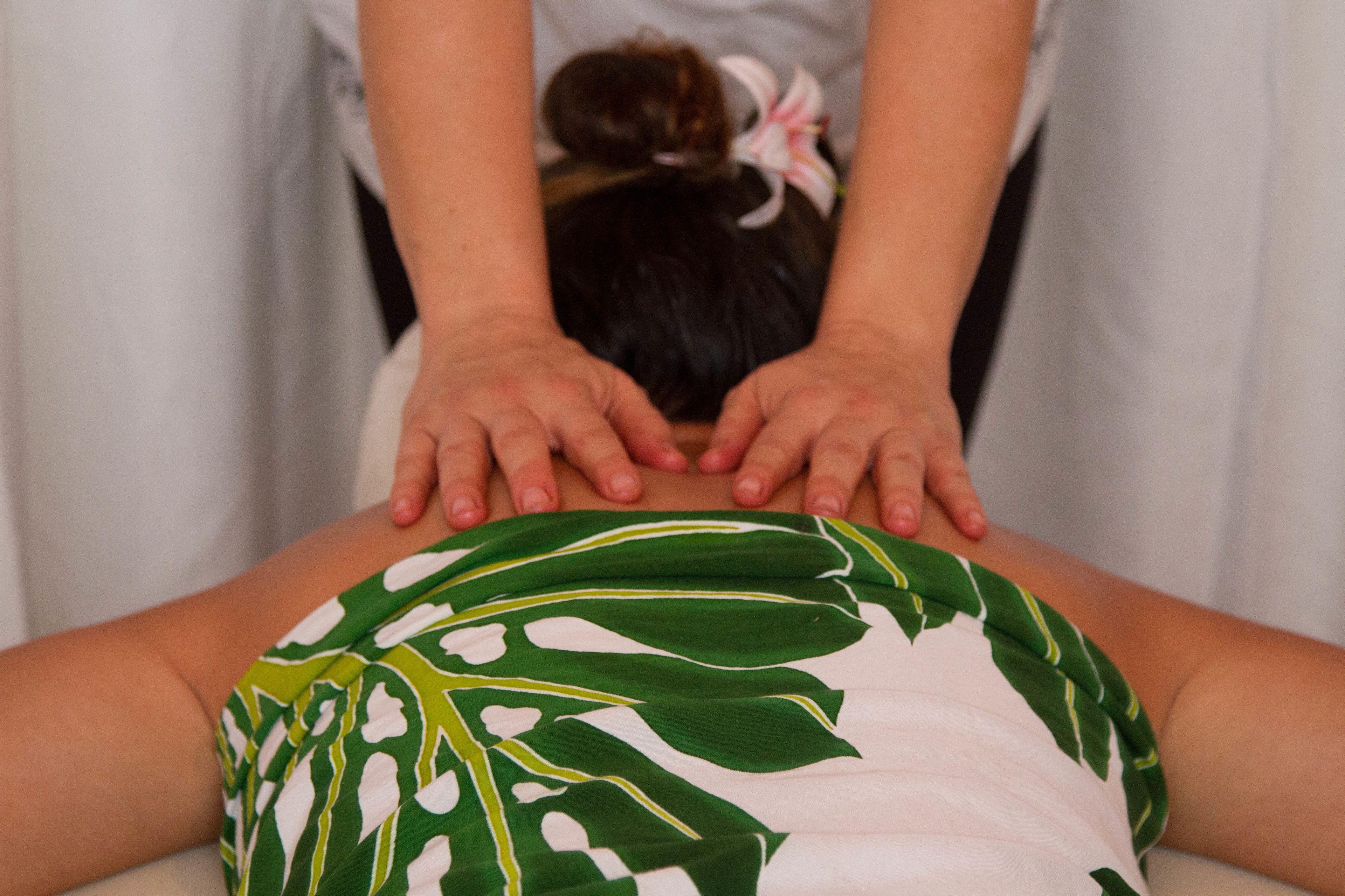 A person receiving a back massage.