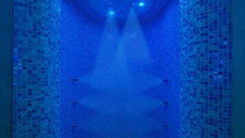 A blue-tiled interior with a central light fixture and a circular skylight.
