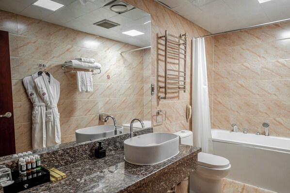 A modern bathroom with a large sink, a bathtub, and a shower.