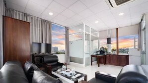 A modern hotel room with a living area, a dining space, and a kitchen. - Diamond Luxury Ben Thanh (Ho Chi Minh City)