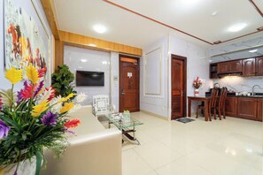 Family Apartment (For 5) | Living area | 43-inch plasma TV with cable channels, TV, video-game console - Diamond Luxury Ben Thanh (Ho Chi Minh City)