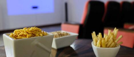 A table with two bowls of food and a projector screen in the background.