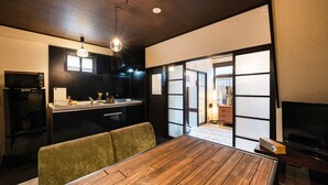 A compact kitchen with a microwave, refrigerator, and a small countertop with a sink and coffee maker. - Shiori (Kyoto)