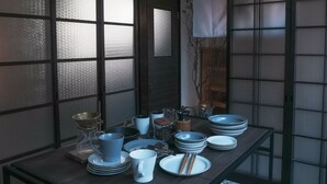 A dining table with various dishes, glasses, and utensils. - Shiori (Kyoto)