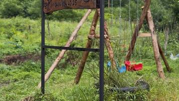 A rustic wooden sign for Zilkale Butik hotel with a contact number.