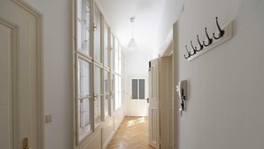 A hallway with wooden flooring, white walls, and large windows. - Heart of Vienna Apartments (Vienna)
