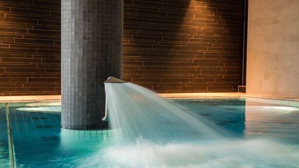 A pool with a water feature shooting up from a column. - Spa Hotel Amsee (Waren (Müritz))
