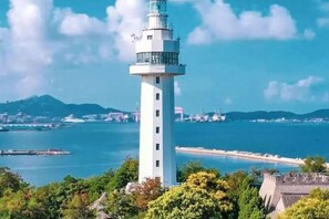A lighthouse with a clear view of the surrounding coastline and water. - Ginza Jiayi Hotel (Yantai Suocheng Wanda Plaza Branch) (Yantai)