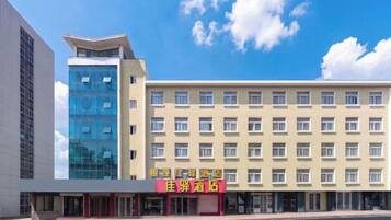 A hotel with a modern building and a separate entrance building.