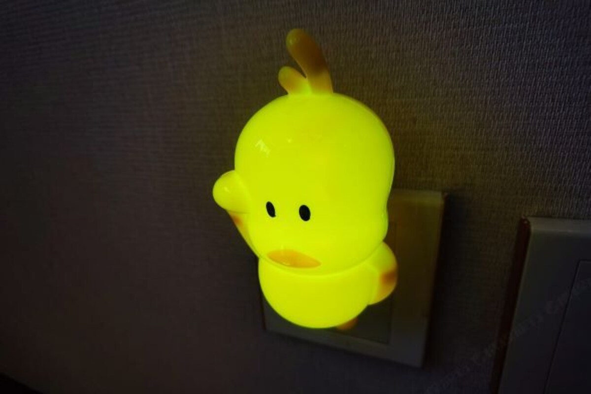 A yellow duck-shaped object on a wall.