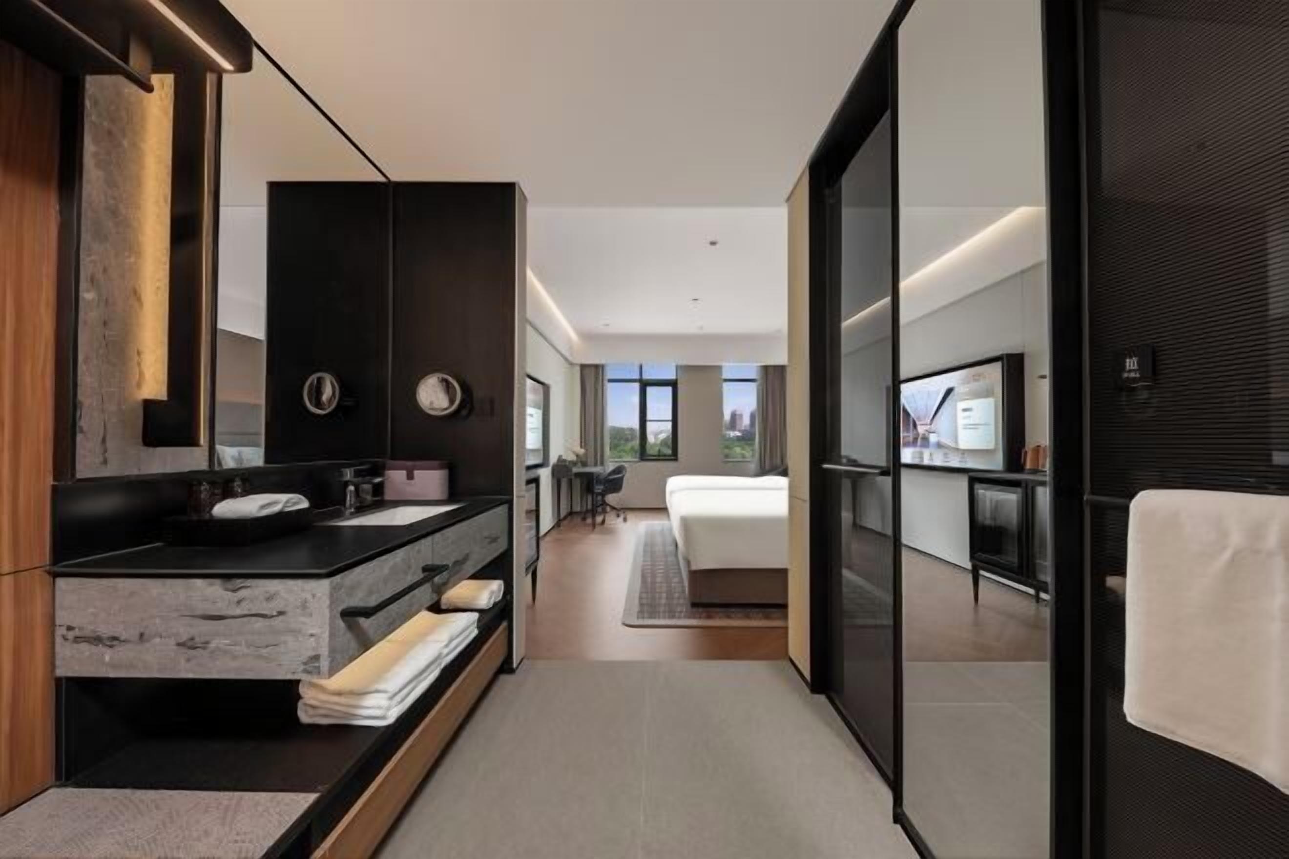 A modern bathroom with a large mirror, a sink, and a vanity.