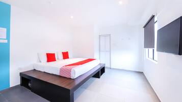 A modern bedroom with a bed, a TV, and a sliding door.