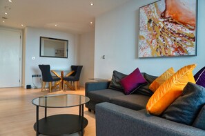 Apartment, 2 Bedrooms, Balcony | Living area | Flat-screen TV, heated floors