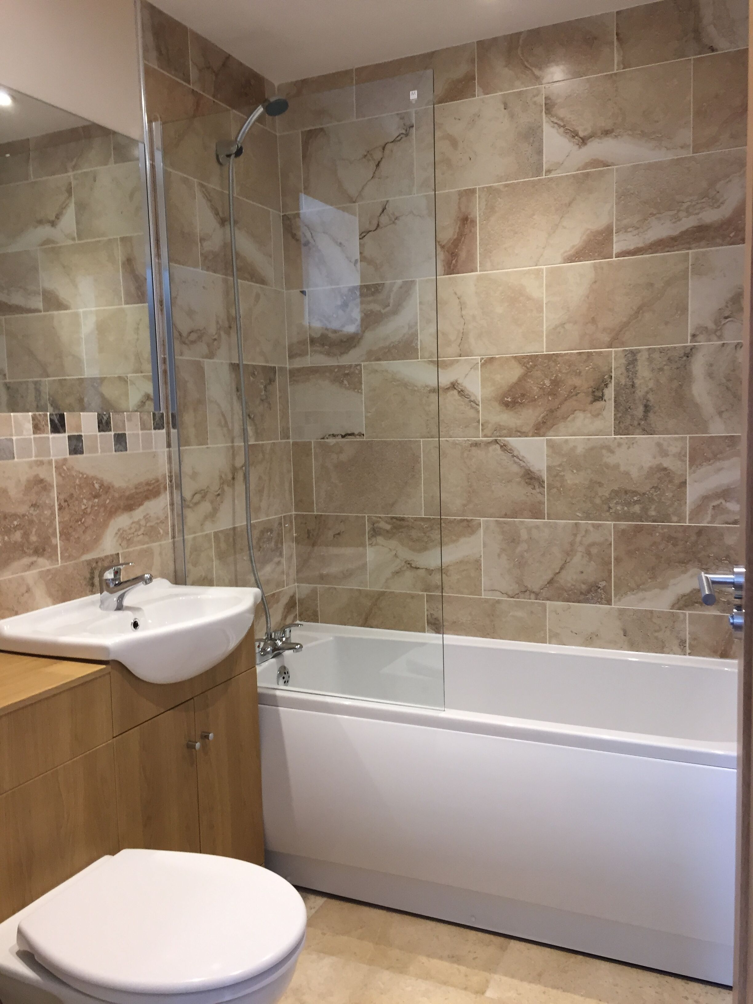 A bathroom with a bathtub, a sink, and a toilet.