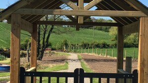 A wooden gazebo with a gravel path leading to a fenced area. - Ashbrook House B&B (Dungannon)